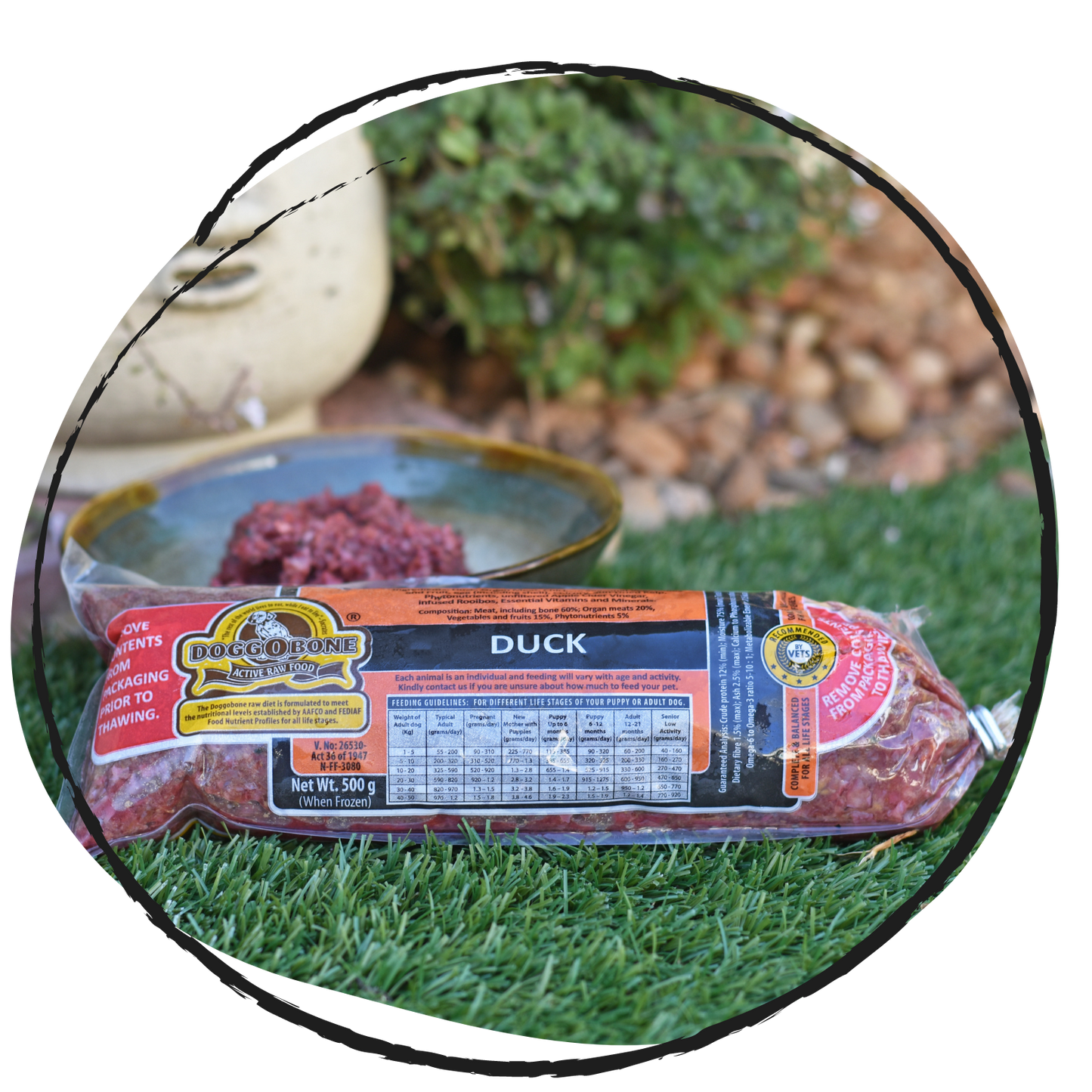 Doggobone Raw Dog Food Duck Meal 500g in a garden