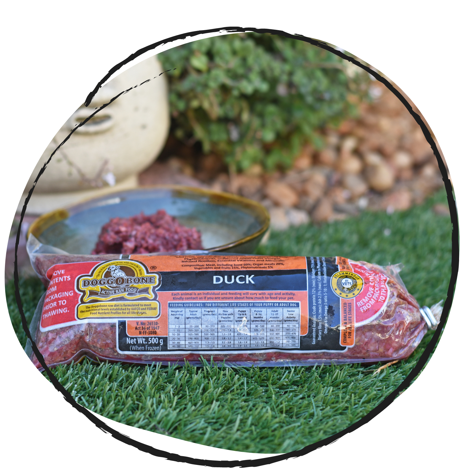 Doggobone Raw Dog Food Duck Meal 500g in a garden